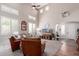 Inviting living room with high ceilings, neutral paint, lots of natural light, and beautiful wood floors at 17538 W Marshall Ln, Surprise, AZ 85388