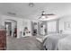Large main bedroom featuring a ceiling fan, carpet flooring, and bright windows at 17538 W Marshall Ln, Surprise, AZ 85388