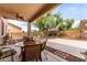 Covered patio with outdoor dining area and view of the basketball court at 17538 W Marshall Ln, Surprise, AZ 85388