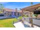 Backyard with gazebo with outdoor seating, fire pit, TV, and pool views at 18014 N 53Rd Pl, Scottsdale, AZ 85254