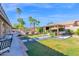 An expansive backyard features a pergola, pool, palm trees, and manicured landscaping at 18014 N 53Rd Pl, Scottsdale, AZ 85254