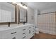 A modern bathroom offers double sinks, quartz counters, and a shower and tub combo at 18014 N 53Rd Pl, Scottsdale, AZ 85254