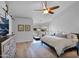 Bright bedroom features a ceiling fan, barn door access, and an attached exercise area at 18014 N 53Rd Pl, Scottsdale, AZ 85254