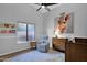 Bedroom with plush rug, recliner, and a playful painting on the wall at 18014 N 53Rd Pl, Scottsdale, AZ 85254