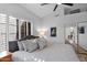 Bedroom featuring large windows with plantation shutters and sliding mirrored closet at 18014 N 53Rd Pl, Scottsdale, AZ 85254