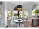 Cozy breakfast nook with a round table, stylish chairs, and natural light from arched windows at 18014 N 53Rd Pl, Scottsdale, AZ 85254