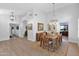 Elegant dining room with wood table, hardwood floors, and modern lighting at 18014 N 53Rd Pl, Scottsdale, AZ 85254