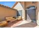 Inviting front entrance featuring a courtyard seating area and secure decorative metal gate at 18014 N 53Rd Pl, Scottsdale, AZ 85254