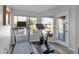 Bright exercise room features a treadmill, stationary bike, and an exterior door at 18014 N 53Rd Pl, Scottsdale, AZ 85254