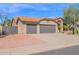 Single-story home with desert landscaping, three-car garage and neutral-colored exterior at 18014 N 53Rd Pl, Scottsdale, AZ 85254