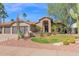 Charming single-story home with a well-manicured front yard, desert landscaping, and three-car garage at 18014 N 53Rd Pl, Scottsdale, AZ 85254