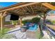 Gazebo with outdoor seating, fire pit, TV, ceiling fan, and backyard views at 18014 N 53Rd Pl, Scottsdale, AZ 85254