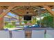 Gazebo with outdoor seating, fire pit, TV, ceiling fan, and backyard views with pool at 18014 N 53Rd Pl, Scottsdale, AZ 85254