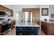 Modern kitchen featuring dark wood cabinetry, stainless appliances, and center island at 18014 N 53Rd Pl, Scottsdale, AZ 85254