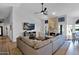 Inviting living room featuring a stone fireplace, large sectional sofa, and a ceiling fan at 18014 N 53Rd Pl, Scottsdale, AZ 85254