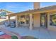 Covered patio with multiple seating options, ceiling fan, and access to the backyard at 18014 N 53Rd Pl, Scottsdale, AZ 85254