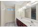 Well-lit bathroom with double sinks, vanity, tile flooring and a large mirror at 1836 N Stapley Dr # 4, Mesa, AZ 85203