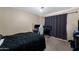 Comfortable bedroom with ample space, a ceiling fan, and blackout curtains for peaceful rest at 1836 N Stapley Dr # 4, Mesa, AZ 85203