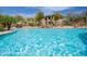 Sparkling community pool offering desert views, lush landscaping, rock waterfall and seating at 19700 N 76Th St # 2001, Scottsdale, AZ 85255