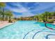 Resort-style community pool with lush landscaping, rock waterfall and seating area at 19700 N 76Th St # 2001, Scottsdale, AZ 85255