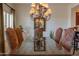 Stylish dining room showcases a glass table, a decorative chandelier, and seating for six at 19700 N 76Th St # 2001, Scottsdale, AZ 85255