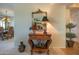 Foyer with decorative table, mirror, and view to dining area with elegant chandelier at 19700 N 76Th St # 2001, Scottsdale, AZ 85255
