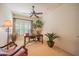 Bright home office boasts shuttered windows, ceiling fan, and classic wooden desk and furnishings at 19700 N 76Th St # 2001, Scottsdale, AZ 85255