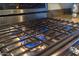 The gas range top has blue flames coming from under the black grates at 19700 N 76Th St # 2001, Scottsdale, AZ 85255