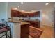 Well-appointed kitchen with dark wood cabinets, granite countertops, and stainless steel appliances at 19700 N 76Th St # 2001, Scottsdale, AZ 85255