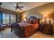 Spacious main bedroom with ceiling fan, shutters, and a plush king bed at 19700 N 76Th St # 2001, Scottsdale, AZ 85255