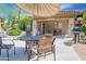 Outdoor dining space offers seating and shade for residents to enjoy in the community pool area at 19700 N 76Th St # 2001, Scottsdale, AZ 85255