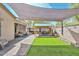 Spacious backyard featuring a gazebo, outdoor kitchen, artificial grass, patio shade and comfortable seating at 20338 N 262Nd Ave, Buckeye, AZ 85396