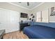 A well-organized bedroom with mounted television, closet, and sleek dresser on wood flooring at 20338 N 262Nd Ave, Buckeye, AZ 85396