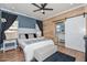 A cozy bedroom with barn door bathroom entry, stylish décor, and comfortable furnishings at 20338 N 262Nd Ave, Buckeye, AZ 85396