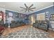 Cozy bonus room with a large ceiling fan, comfortable seating, and space for relaxation and entertainment at 20338 N 262Nd Ave, Buckeye, AZ 85396