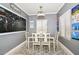 Traditional dining room features gray walls, a rectangular table, six chairs, and modern style light fixture at 20338 N 262Nd Ave, Buckeye, AZ 85396