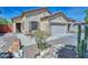 Attractive home with desert landscaping, a two-car garage, and a welcoming front entrance walkway at 20338 N 262Nd Ave, Buckeye, AZ 85396