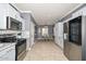 Bright and airy kitchen with stainless steel appliances, granite countertops, tile floors, and a view into dining area at 20338 N 262Nd Ave, Buckeye, AZ 85396