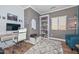 The home office features a modern desk, white shelving and a cozy blue chair at 20338 N 262Nd Ave, Buckeye, AZ 85396