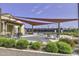 Pickleball courts with shaded seating, surrounded by lush landscaping and community gathering spaces at 20338 N 262Nd Ave, Buckeye, AZ 85396