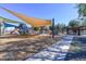 Community playground with slides, shaded seating, and covered play structures for outdoor fun at 20338 N 262Nd Ave, Buckeye, AZ 85396