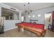 Game room features a pool table, bar seating and views into another room at 20338 N 262Nd Ave, Buckeye, AZ 85396