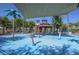 Interactive splash pad with water features, shaded structures, and colorful elements for children at 20338 N 262Nd Ave, Buckeye, AZ 85396