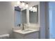 Modern bathroom with a white vanity, a bright mirror, and a brushed nickel faucet at 225 N Pomeroy -- # 16, Mesa, AZ 85201