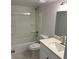 Well-lit bathroom featuring a shower-tub combo and a modern vanity with a white countertop at 225 N Pomeroy -- # 16, Mesa, AZ 85201