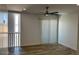 Bright bedroom with wood floors, a ceiling fan, and a sliding glass door at 225 N Pomeroy -- # 16, Mesa, AZ 85201