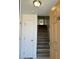 Open entryway view of condo with wooden staircase and white closet doors at 225 N Pomeroy -- # 16, Mesa, AZ 85201