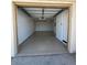 Empty single car garage with white painted walls and concrete flooring at 225 N Pomeroy -- # 16, Mesa, AZ 85201