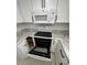 Modern kitchen with white cabinets and updated appliances, including a microwave and oven at 225 N Pomeroy -- # 16, Mesa, AZ 85201