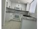 Updated kitchen featuring white cabinets, modern appliances, stainless steel sink, and tile flooring at 225 N Pomeroy -- # 16, Mesa, AZ 85201